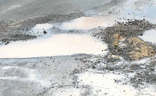 Pot holes made regular appearances on roads during storm season. Pot holes made regular appearances on roads during storm season.